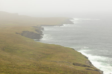 Fog in the fields and ocean, Valentia island, Kerry, Irelandの写真素材