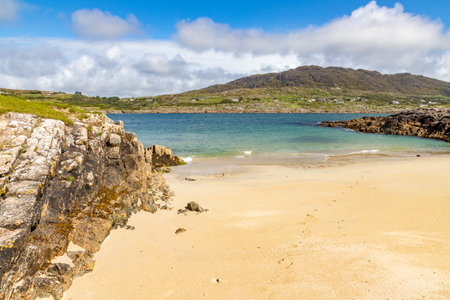 Beach with mountain and houses in background, Dogs bay, Roundstone, Conemara, Galway, Irelandの写真素材