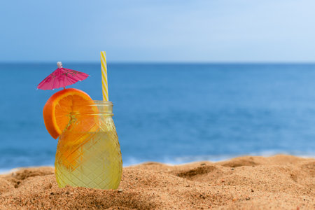 close-up cocktail on the beach with the sea in the backgroundの写真素材