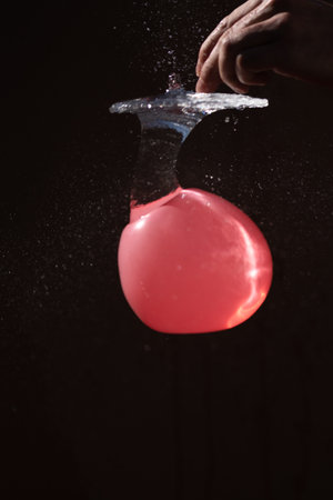 balloon filled with water is punctured and the exploding water takes the shape of a mushroomの写真素材