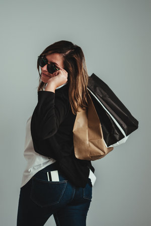 girl with her shopping bags on her shoulder looking backwards