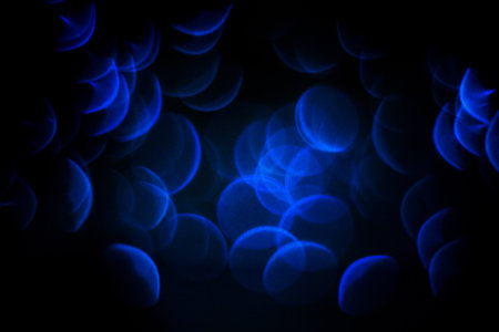 Abstract background with christmas lights in boken. Bright blue color texture for design. Background concept.の写真素材