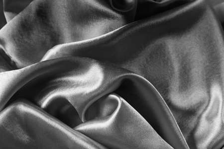 Elegant bright satin with waves. Fabric backdrop, view from above. Luxury cloth texture. Prefect as an abstract background with copy space, close-up.の写真素材