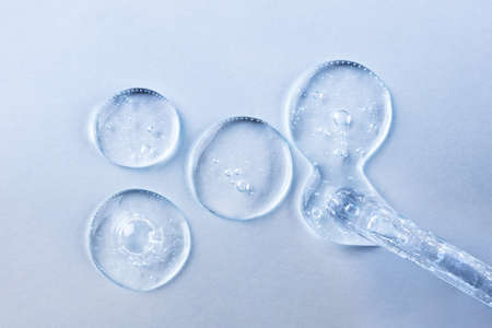 Transparent gel or serum pipette with drops. Cosmetics concept with fluid. Minimalism style and...