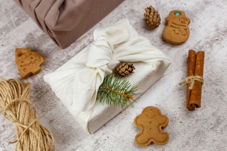 Christmas eco friendly gift wrapping in traditional Japanese Furoshiki style. Environmental present...