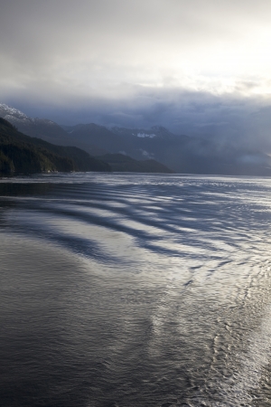 Misty skies   reflective waters ona calm day in the Queen Charlotte Strait, British Columbia, Canadaの写真素材