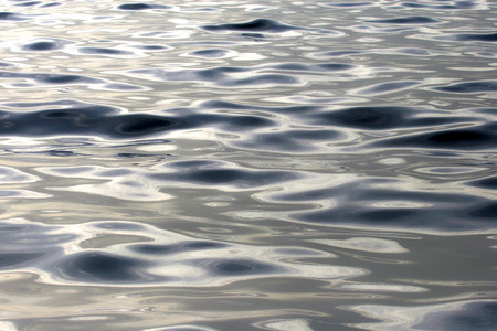 Close up of the sea with a slight ripple from waves  Dark blue with beautiful light reflecting on...