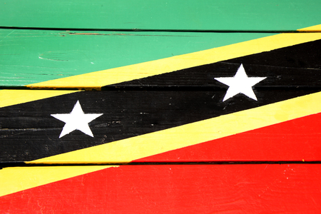 Flag of St Kitts & Nevis painted on wooden planks, in bright colours of red, yellow, green & black.の写真素材