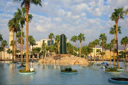 Water feature in a man made lake surrounded by palm trees, as a beauttiful landmark in Aqaba, Jordan.の写真素材