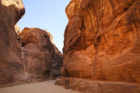 Path through the Siq, which is the narrow gorge passage that you walk along to reach Petra, Jordan.の写真素材