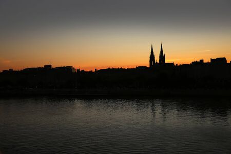 Silhouette of the skyline of the city of Bordeaux, at sunset with church steeples & the river Garonne in the foreground, France.の写真素材
