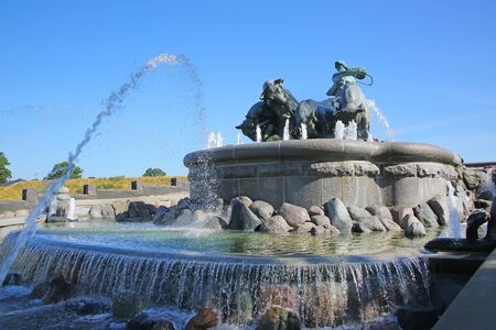 The Gefion Fountain with a group of animal figures being driven by the Norse goddess Gefjon on the harbour front, Nordre Toldbod in Copenhagen, Denmark.の写真素材