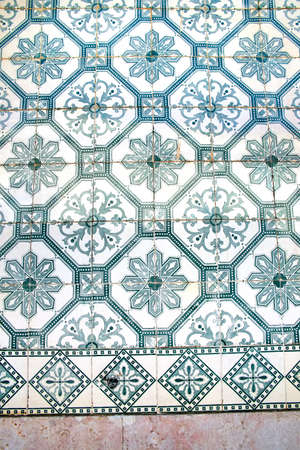 Glazed blue ceramic tiles or azulejos  which cover many buildings in Lisbon, Portugal. These...
