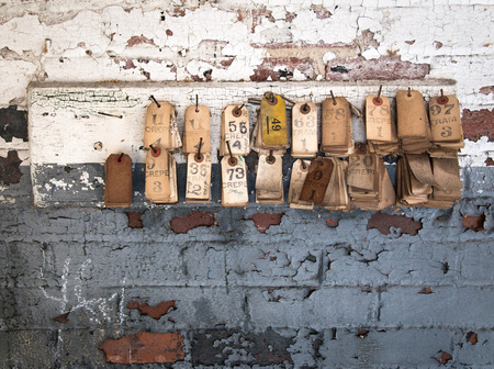 Vintage Tags on a Wall of an Abandoned Millの写真素材