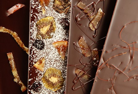 Hand-made bars of chocolate mixed with dried fruit and coconut.の写真素材