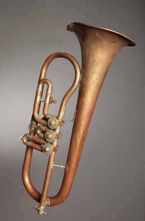 An old trumpet against grey background.の写真素材