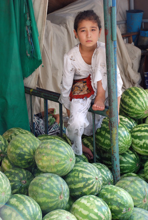 Girl with watermelons on the Uzbek marketのeditorial素材