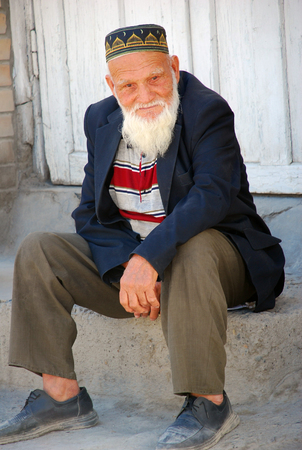 Elderly Uzbek - grandfather sitting on a stoneのeditorial素材