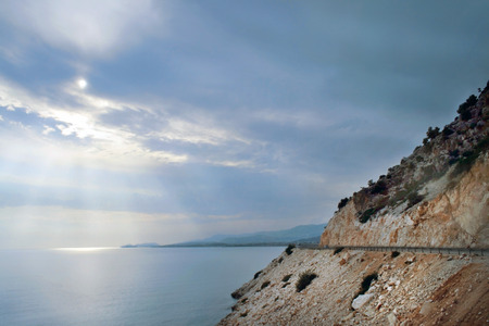 Sun rays through the clouds above the Aegean Seaの写真素材