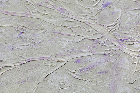 Background of crumpled tracing paper and purple paint brush strokesの写真素材