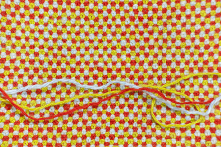 Knitted, woolen fabric and three threads of which it is connected
