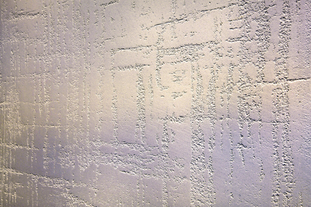 Colored texture of plaster with strips. The relief surface of the wall is a decorative coating....