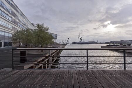 Bridge over the sea channel at dusk and view of the industrial port in Aarhus. Denmark.のeditorial素材