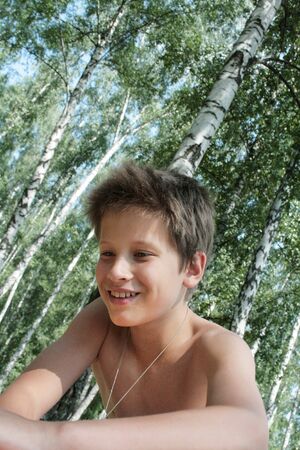 Happy boy in a birch grove. Portrait of a Russian teenager - 12 years oldの写真素材