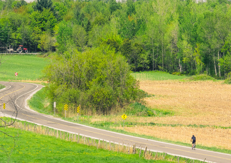 A cyclist walking on a beautiful Sunday in the countryside.の写真素材