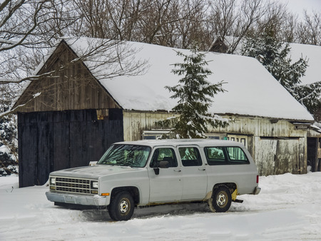 This station wagon is located in the countryside near an old barn. Photo taken in winter in Roxton Falls, Quebec, Canada; February 16, 2017.のeditorial素材