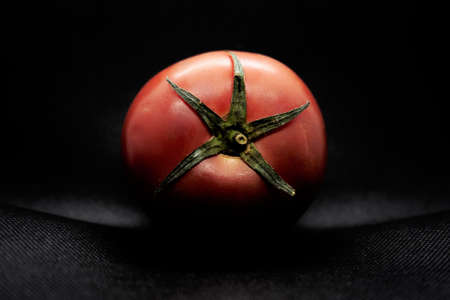 This fruit-vegetable is very good and very nutritious. It is installed on a table which has a black cloth. It is taken in macro. Ulverton, Quebec, Canada; May 6, 2019.の写真素材