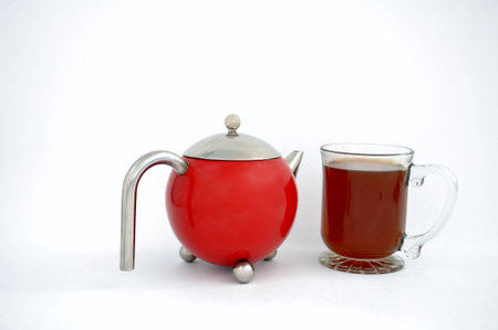 teapot and mug of tea isolated on a white backgroundの写真素材
