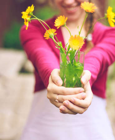 Female hands with bouquet of flowersの写真素材