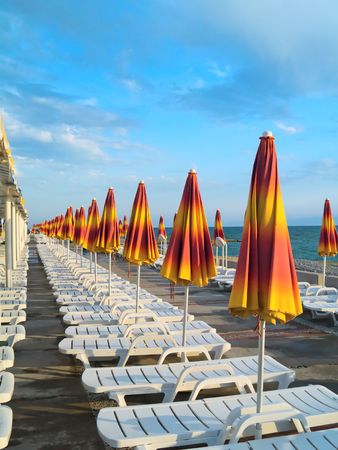 A lot of yellow summer umbrellas. It`s look like infinityの写真素材