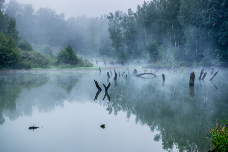 Misty morning with a lot of fog on a small river in Russia.の写真素材