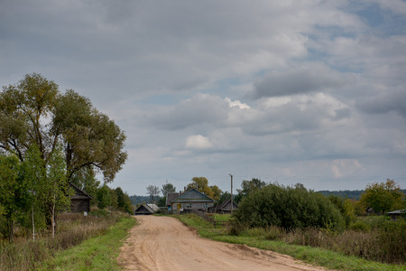 Rural autumn landscape. Solitude russian village with old wooden housesの写真素材