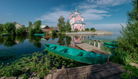 Wooden boat on a river bank near church in russian provincial town Pereslavl-Zalessky.の写真素材