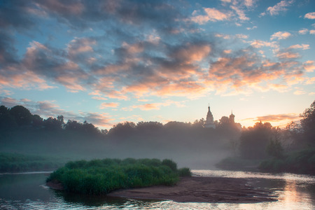 Early morning in small russian village with orthodox church at the hilltopの写真素材