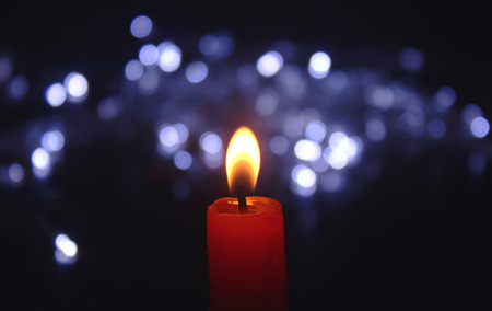 Candle with christmas lightsの写真素材