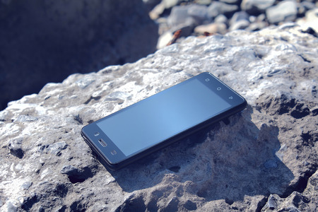 Medern Smartphone on a stoneの写真素材