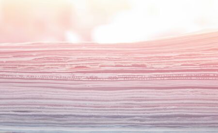 Stack of newspapers close up background, soft light