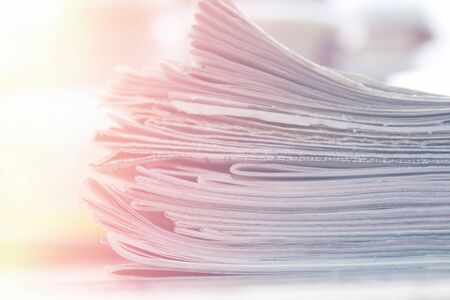 Stack of newspapers close up background, soft lightの写真素材