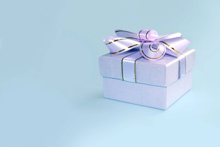 A gift with a beautiful ribbon isolated on blue background
