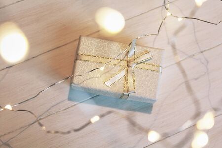 A gift box with a burning garlandの写真素材