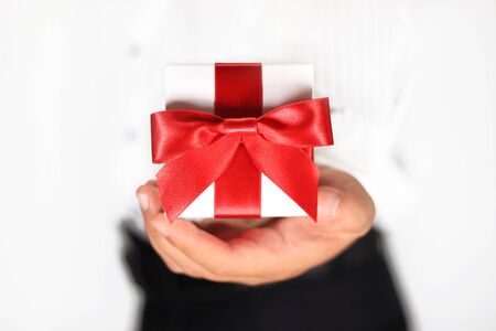 Male hand holding a gift boxの写真素材