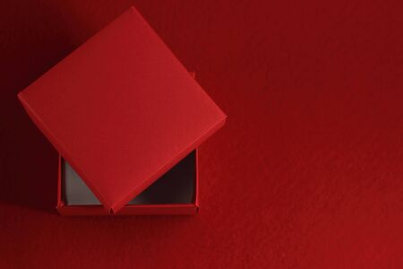 Opened empty red gift box on red backgroundの写真素材