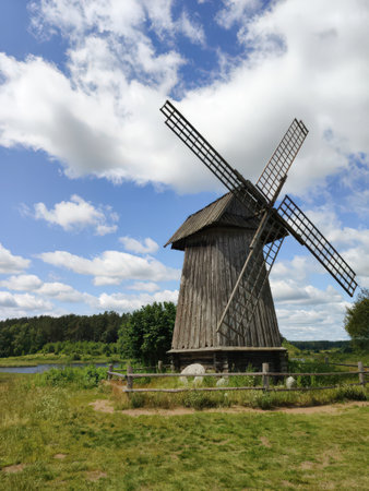 An old wooden windmill on a summer day. Mikhailovskoye Estate. Pushkin Hills, Russia. Landmark,...
