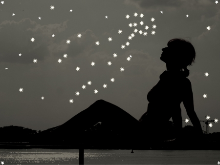 Girl on a background of the night sky with starsの写真素材