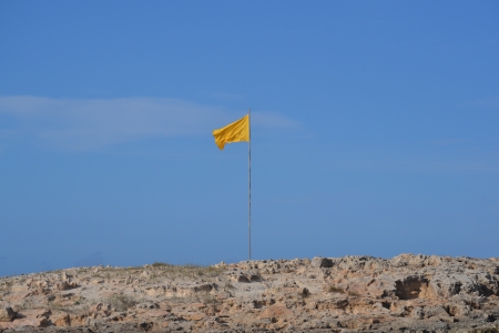 yellow flag on the beachの写真素材