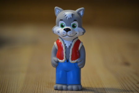 Toy gray wolf in a blue suitの写真素材